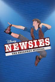 A man is performing on the stage of disney 's newsies.